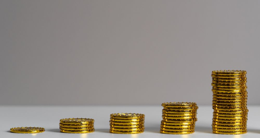 Ilustración usada en una entrada del blog de Chapa Cambio sobre cómo invertir en bonos en el Perú que muestra pilas crecientes de monedas doradas lo que simboliza el crecimiento y los rendimientos que se pueden obtener al invertir en bonos en el mercado peruano